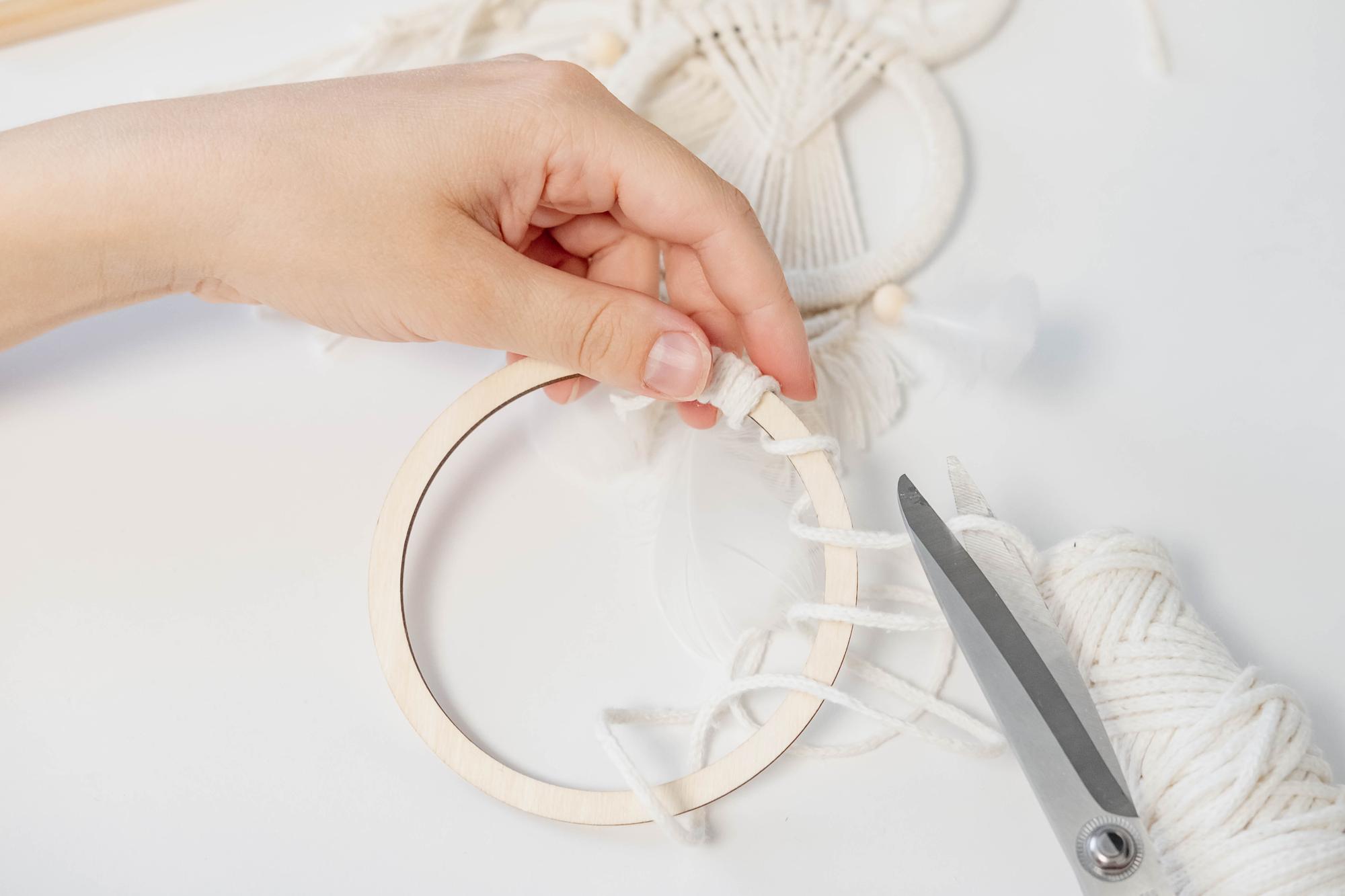artist at work stitching an embroidered motif
